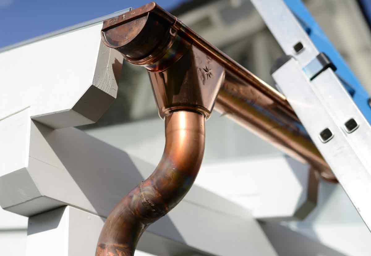 Copper Gutters Being Repaired At a Home